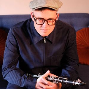 Colour photograph of Adrian Cox holding his clarinet