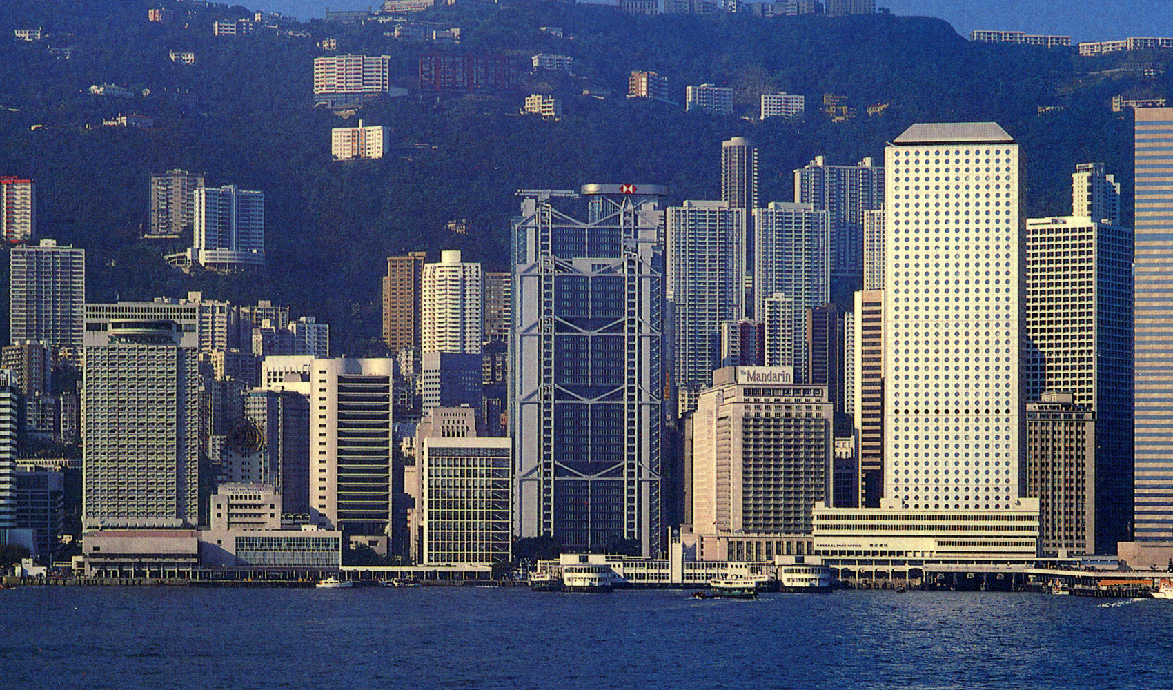 Pedestrians crossing the street in front the of the 1952 HSBC Calcutta building.